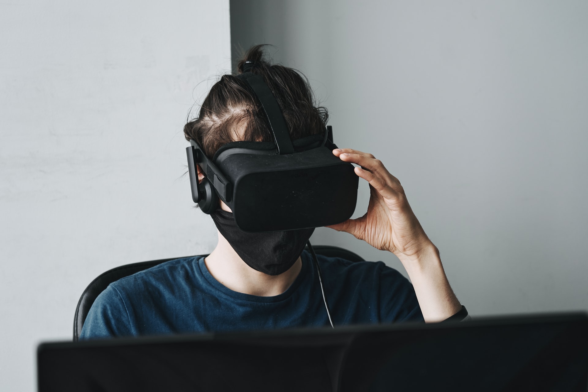 man using VR headset in office